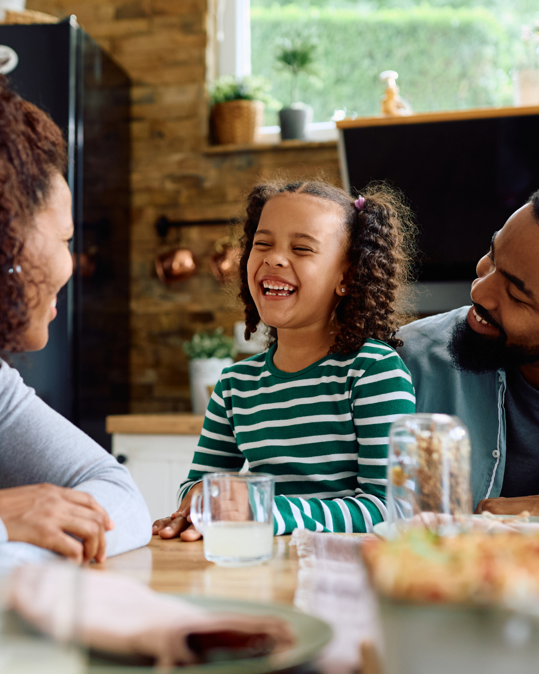 A family laughing together outdoors