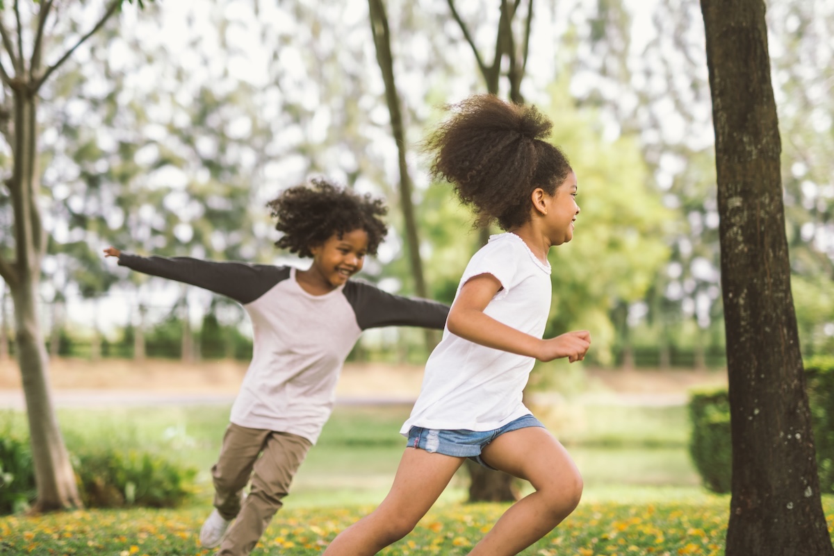 Two children running and playing outdoors